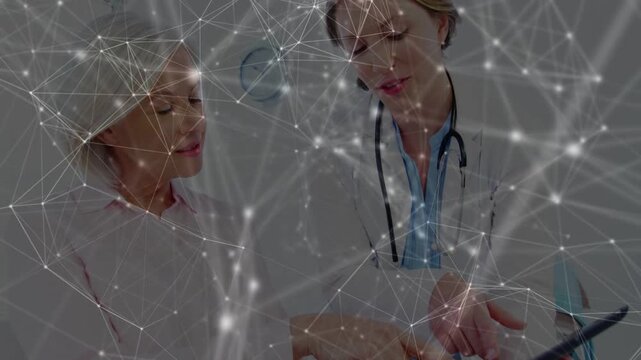 Clinician holding tablet, tapping and showing health data, patient watching under network overlay