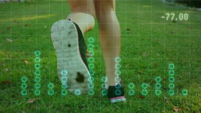 Adult woman's lower legs jogging across grass, lifting foot and updating fitness grid and readouts