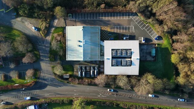 Cinematic aerial view of a massive UK data center at a Worcestershire industrial park during daylight hours