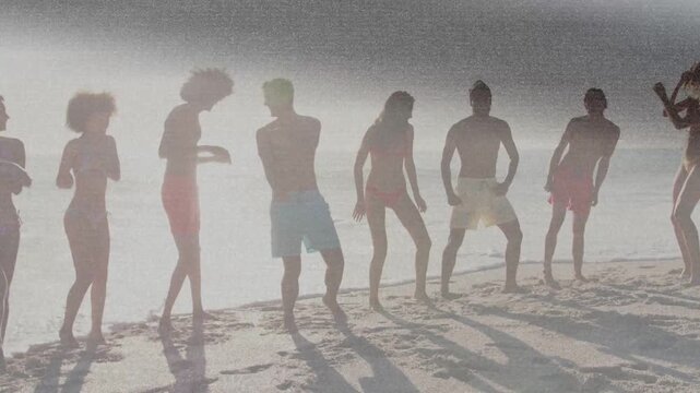 Adults responding to leader clap moving in synced shore dance for travel promo with long shadows