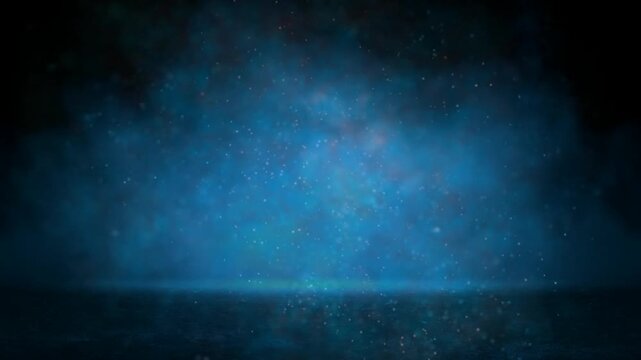 Cinematic abstract dark blue background with smoke and glowing particles.