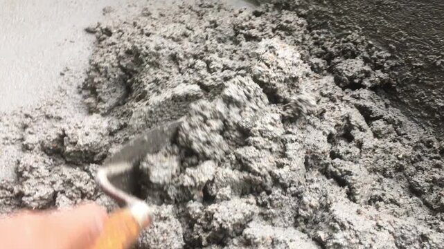 Mixing together to make a strong concrete floor, Mixing concrete concept, Slow motion