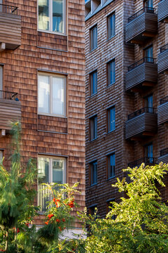 Residential building in Stockholm Hagastaden highlights modern urban architecture with wood facade balconies and windows shaping contemporary city housing