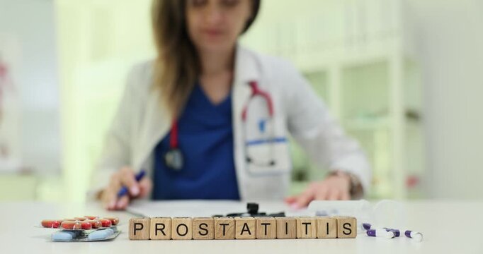 Wooden blocks spell word Prostatitis on desk near scattered pills. Doctor writes diagnosis notes reviewing symptoms and selecting treatment plan