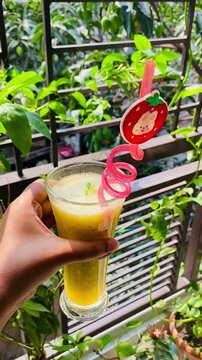 A glass of homemade raw mango drink served in a glass. A traditional Indian recipe of delicious and tangy raw mango drink. Aam Panna is a vegan, gluten free unripe green mango drink or sherbet.