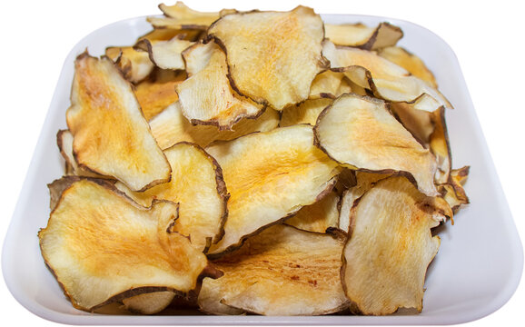 Organic Jerusalem artichoke chips in white dish isolated on transparent background, PNG