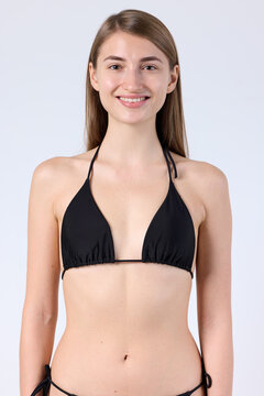 Studio Portrait of Smiling Model in Black Halter Bikini Top