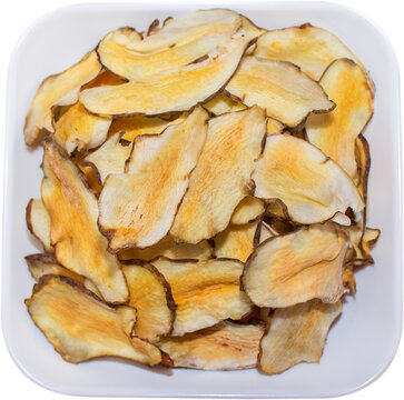 Organic Jerusalem artichoke chips in white dish isolated on transparent background, PNG