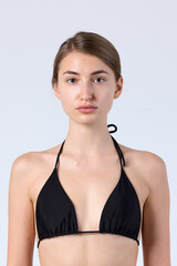 Fototapeta premium Studio Portrait of Model in Black Halter Bikini Top