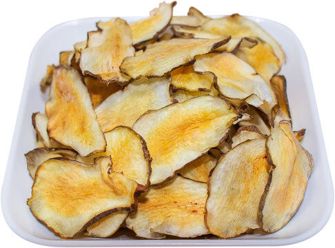Organic Jerusalem artichoke chips in white dish isolated on transparent background, PNG