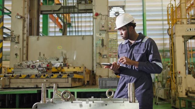 Industrial worker using mobile device in manufacturing facility technical environment professional viewpoint modern industry concept