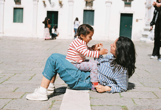 analog film photo of mother and daughter travelling together during summer holidays in Venice, smiling and bonding, concept of motherhood