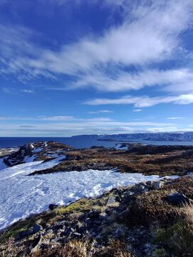 Northern Norway landscape from a hill. Mountains, snow and barents sea