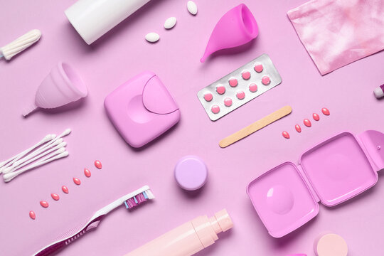 Different feminine hygiene items on pink background