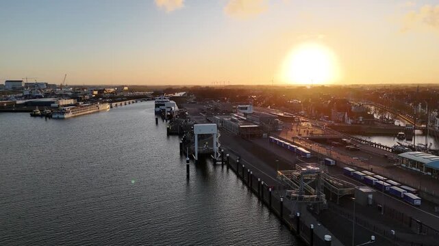 Rearward parallel flight with sunrise over harbor basin