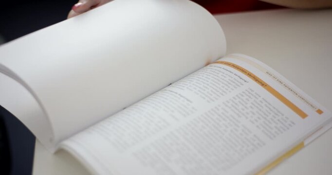 Close-up of a brochure about medical advance directives with pages being flipped on a white table