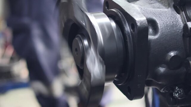 Close up of a heavy duty industrial transmission output shaft spinning rapidly during a performance test. Mechanical power transfer and engineering concept.
