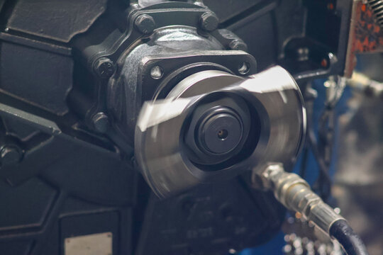 Close up of Allison transmission output shaft spinning during mechanical testing. Professional industrial equipment for heavy vehicle and power systems.