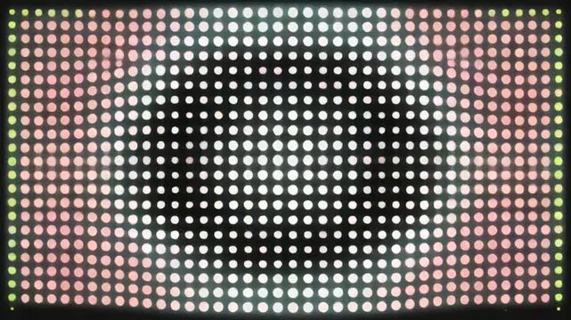 Close-up of led screen displaying vibrant pink and green hues in a grid pattern