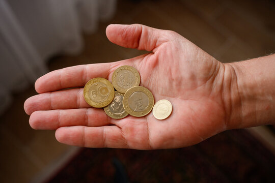 Turkish lira coins in man's hand. Concept of local currency, finance, economy of Turkey, small change, poverty, savings, financial crisis. Close up of metal money in palm, payment, inflation concept