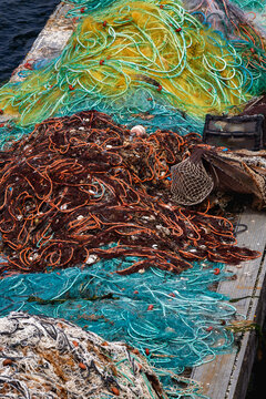 Colorful fishing nets stacked on a fishing pier