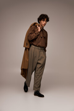 Stylish young man showcases elegant fashion in a modern boutique setting