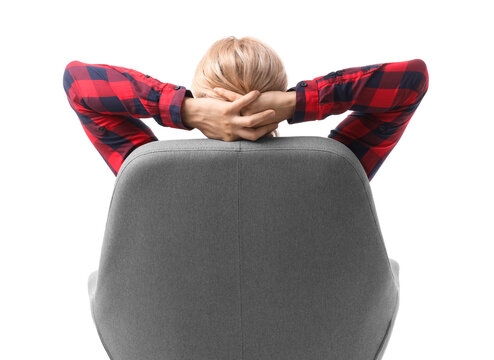 Young man in rocking armchair on white background, back view