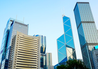 Fototapeta premium Glass skyscrapers in financial district of Hong Kong. Glass building in of Hong Kong's major financial district. Ultra-modern glass tower. Glass windows skyscrapers. Futuristic architecture. 