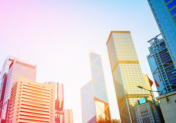 Naklejka premium Glass skyscrapers in financial district of Hong Kong. Glass building in of Hong Kong's major financial district. Ultra-modern glass tower. Glass windows skyscrapers. Futuristic architecture. 