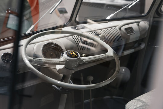 Interior of Volkswagen Transporter T1 classic bus. VW T1 split screen bus with thin-rimmed steering wheel, classic speedometer, and minimalist dashboard. Berlin, Germany - January 16 2026