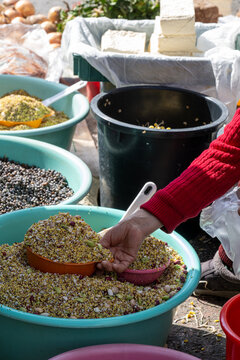 Merchant hands scooping mixed grains at a traditional South Korean street market