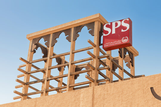 13 January 2026, Dubai, UAE: Smart Police Station - SPS - sign standing on a traditional wind tower structure