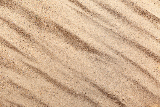 Beach sand with waves as background