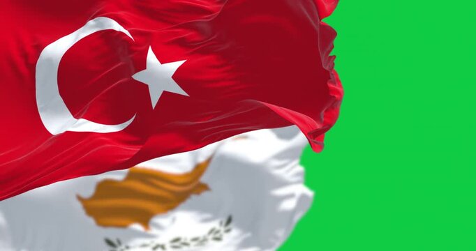 Turkish and cypriot national flags waving in the wind isolated on green background. Seamless 3D render animation. Chroma key. Slow motion loop. Green screen. 4K. Selective focus