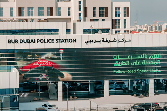 13 January 2026, Dubai, UAE: Bur Police Station building facade with speed limits poster, symbolizing law enforcement, safety
