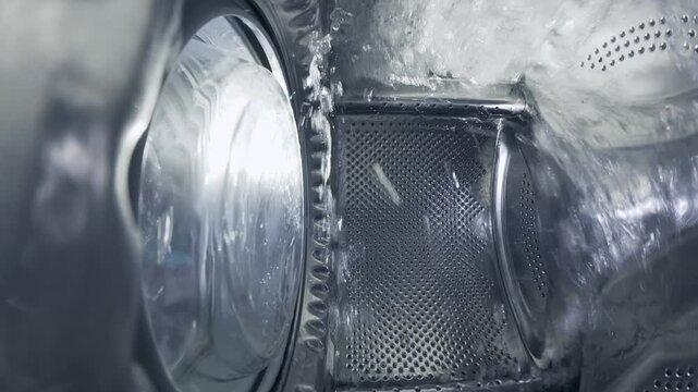 Inside a Rotating Washing Machine Drum with Water Spraying
