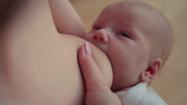 Intimate close-up of newborn baby breastfeeding showing natural nourishment and tender bond. Infant child mother family love parenthood maternity cozy home adorable moment childhood innocence peaceful