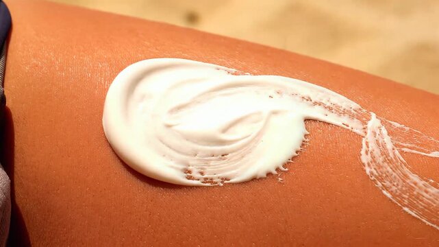 Applying Sunscreen Lotion on Tanned Skin under Bright Sunlight for UV Protection during Summer
