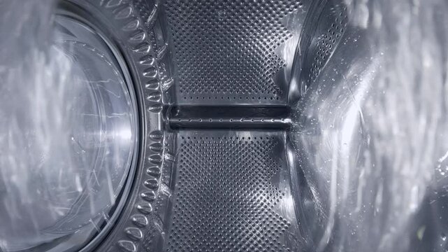 Inside a Rotating Washing Machine Drum with Water Spraying