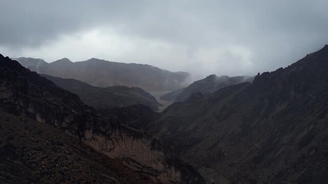 Aerial Of Desert Syncline With Layered Rock Texture In Rain, Noyon Uul, Mongolia