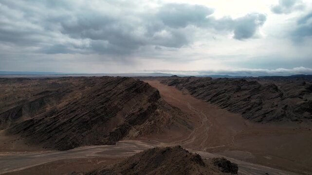Dark Toned Aerial Of Tilted Rock Layers In Desert, Noyon Uul, Mongolia