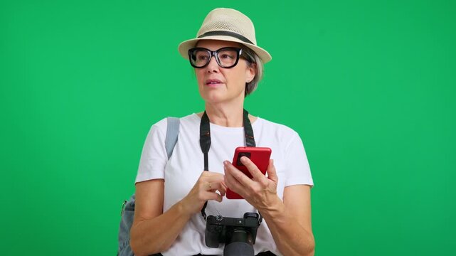 Mature lost female tourist using phone and asking for directions