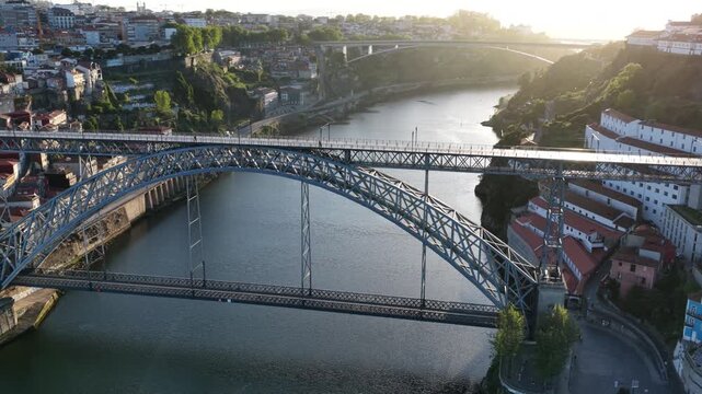 Golden hour flight over Dom Luis I Bridge Douro River Porto Portugal