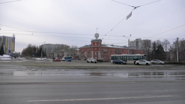 March 22 2026 Barnaul Russia Victory Square building with old clock covered in snow cold early spring urban cityscape historic architecture and winter atmosphere.
