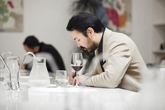 Sommelier Evaluating Wine at Tasting Event