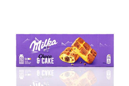 Milka Choco Cake snack packaging photographed in studio on white background with reflection, highlighting chocolate-filled cake product branding.
