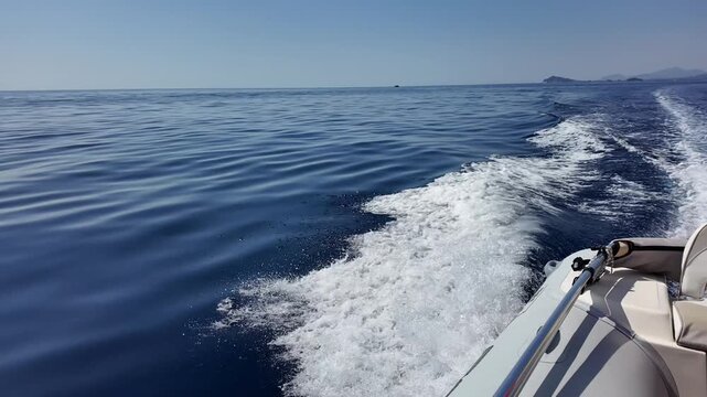 Wake trail from motor boat on sea surface. Movement, speed and travel concept.