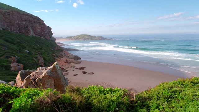 Scenic Robberg Nature Reserve coastal landscape and beach with rolling waves