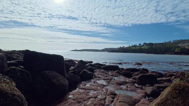 distant view of Dunmore East Harbour and lighthouse from Lawlors strand Dunmore East Waterford Ireland epic locations