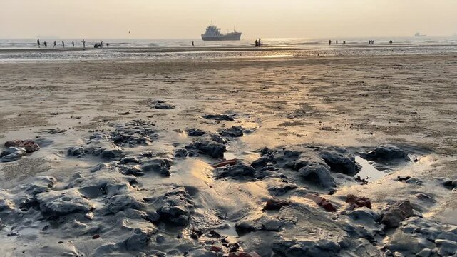 Golden Hour at Parki Sea Beach with Cargo Ship and People, Chittagong, Bangladesh